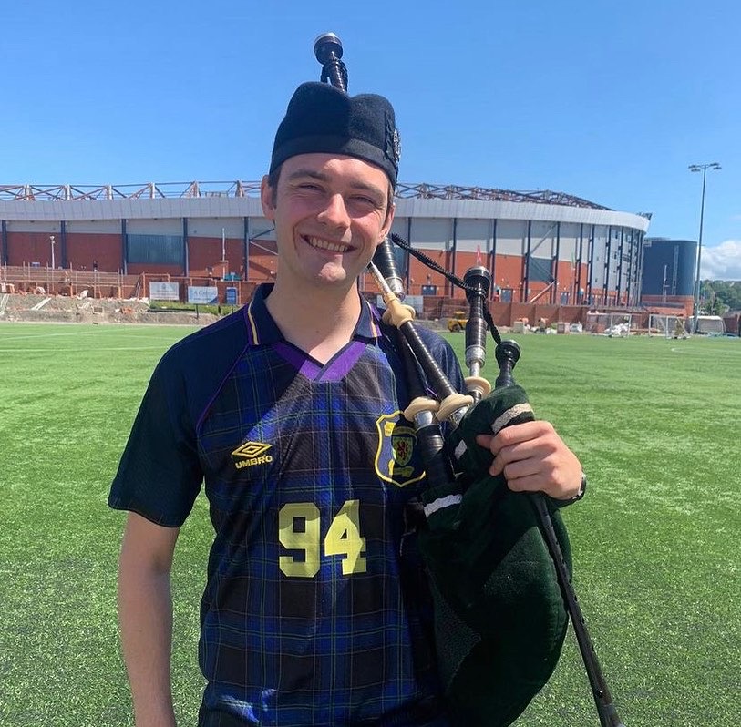 Scottish Piper Hire in Kilt and Scotland football top outside Hampden Park playing for Sky Sports News.